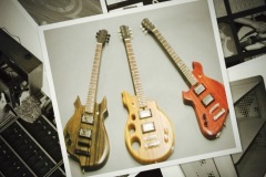 Three wooden guitars made by students and instructors.