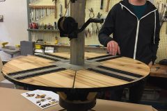 Student shows hand-cranked adjustable table.