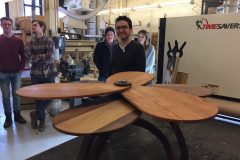 Student and classmates with wooden fen style table.