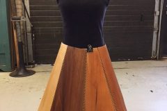 Wooden dress on wood framed mannequin.