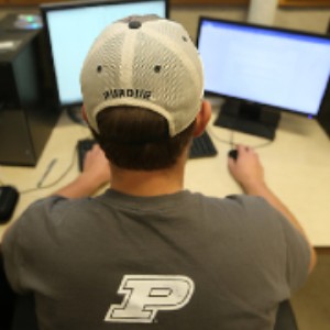 Purdue researcher sits are computer adding new data