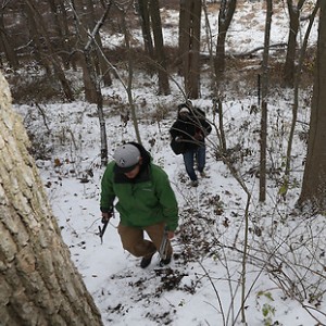 Purdue researchers survery winter woods on foot