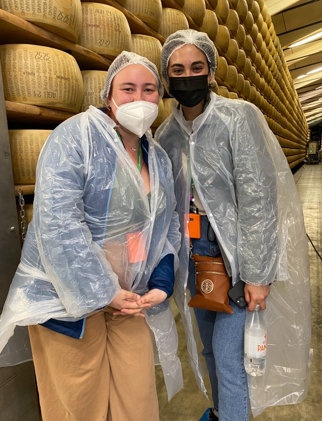 Alexandra with a classmate touring a Parmesan cheese facility in Italy
