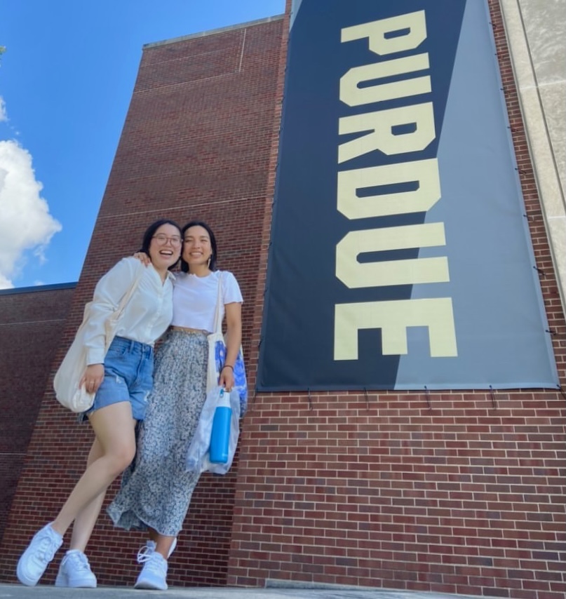 Fernanda Pedroza-Altamirano with a friend in front of Purdue banner