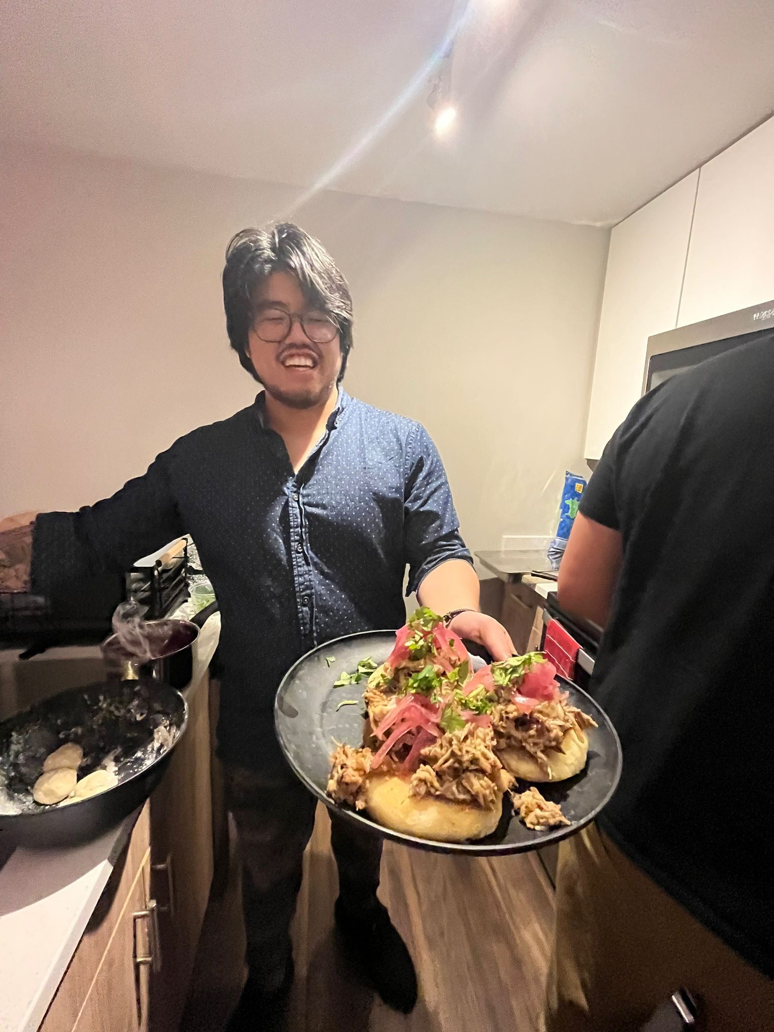 Ryan Lee with a plate of food that he prepared