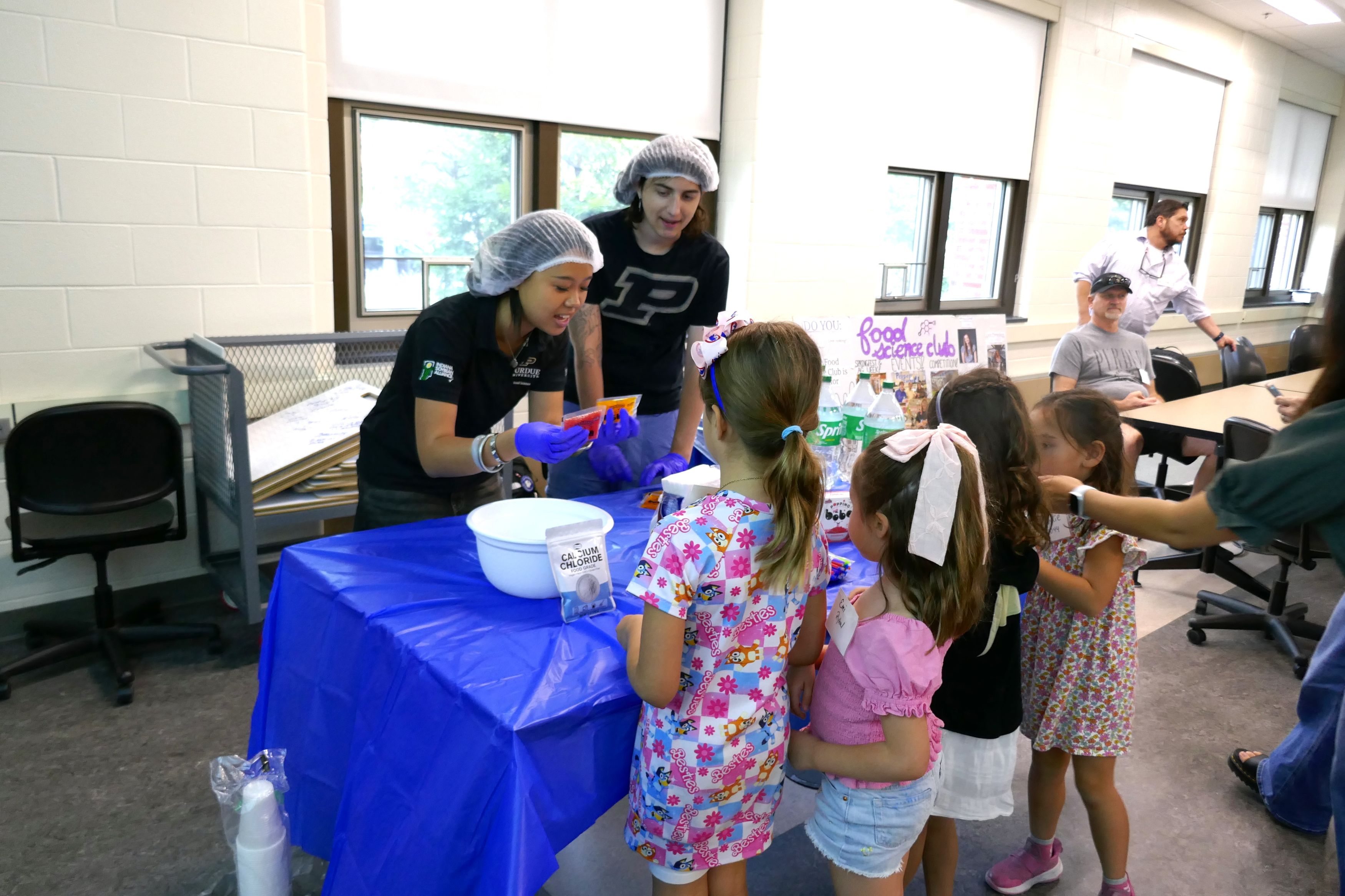 Students explain popping boba to children