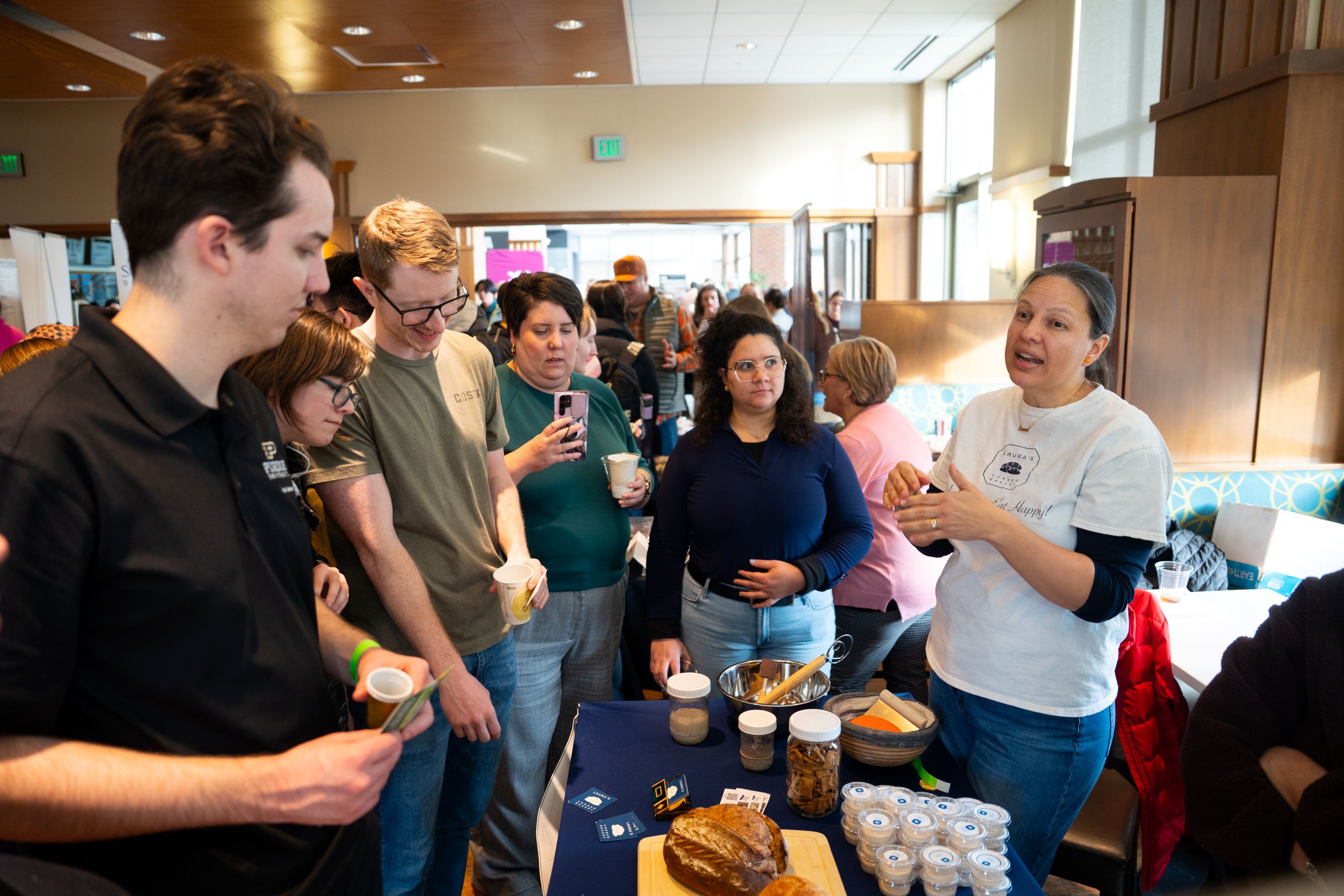 Woman speaks to a group of people about sourdough bread