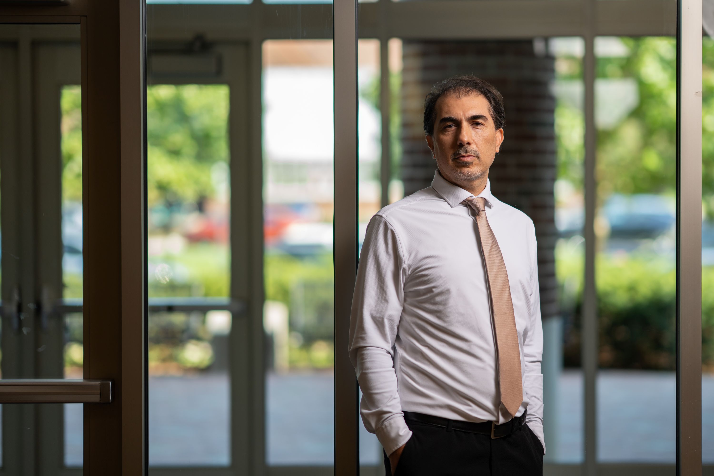 Man standing in front of a wall of glass
