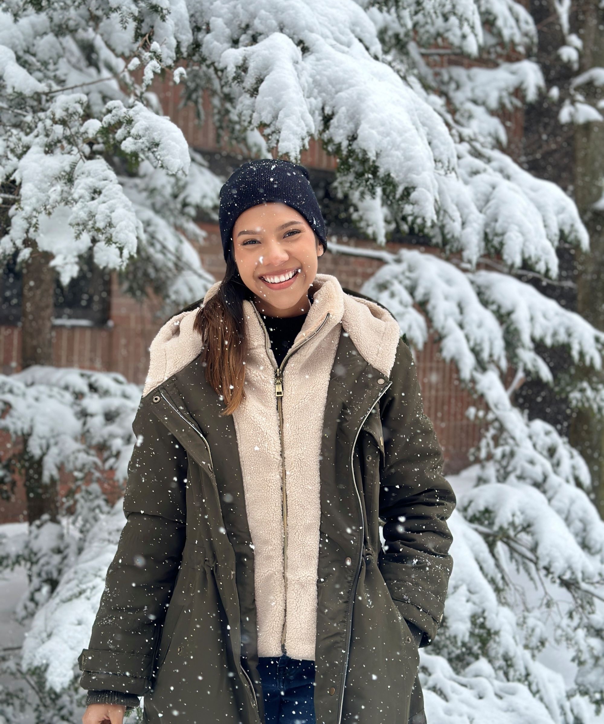 Dalne Sinclair standing in front of a snow-covered tree