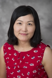Professional headshot of woman wearing a red shirt