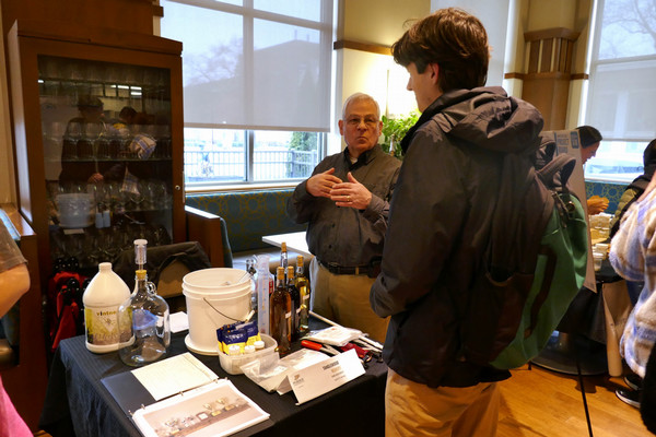Student discusses fermentation with a vendor