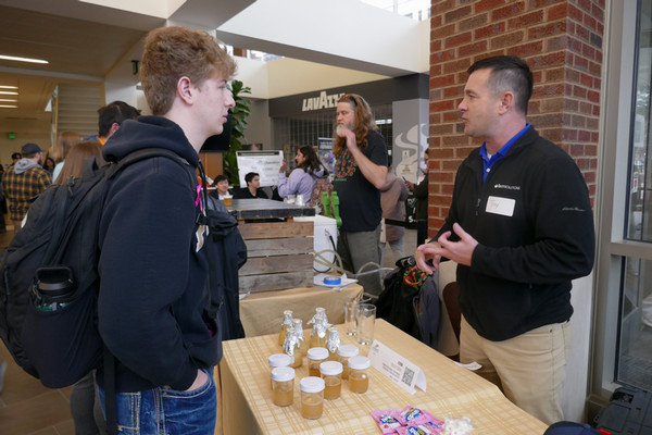 Student talks to a vendor from Ferm Solutions