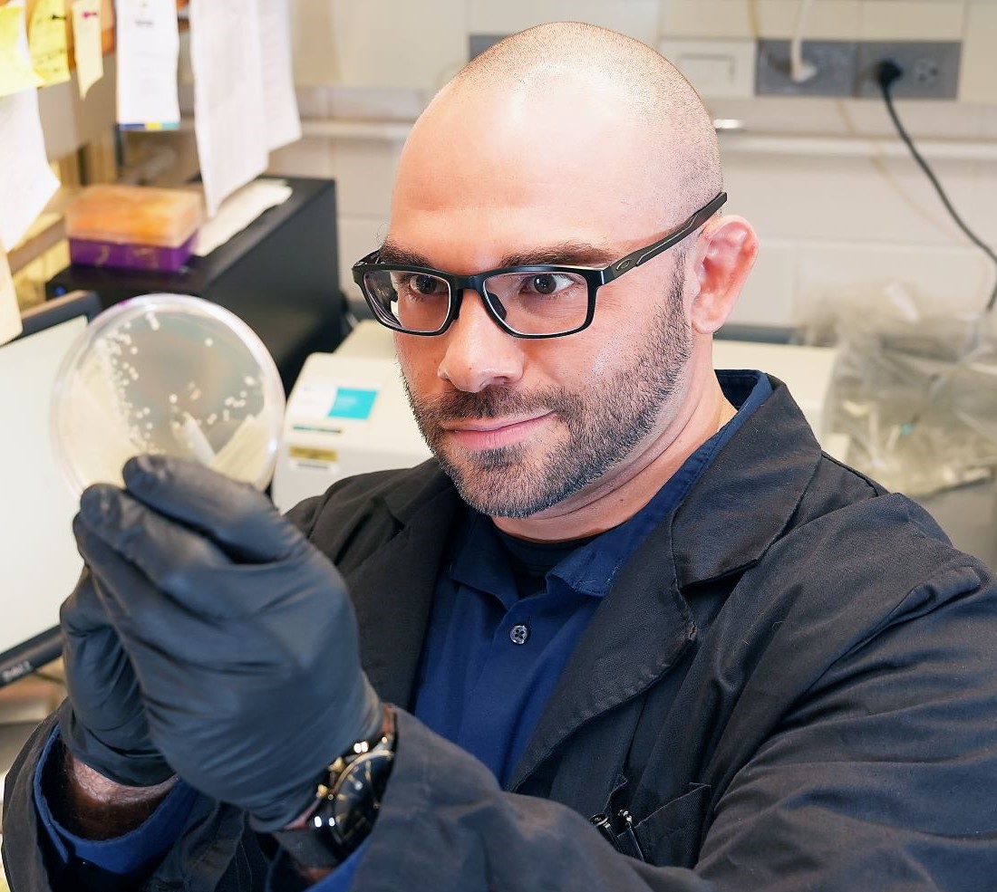 Nicholas Gallina looking at a petri dish