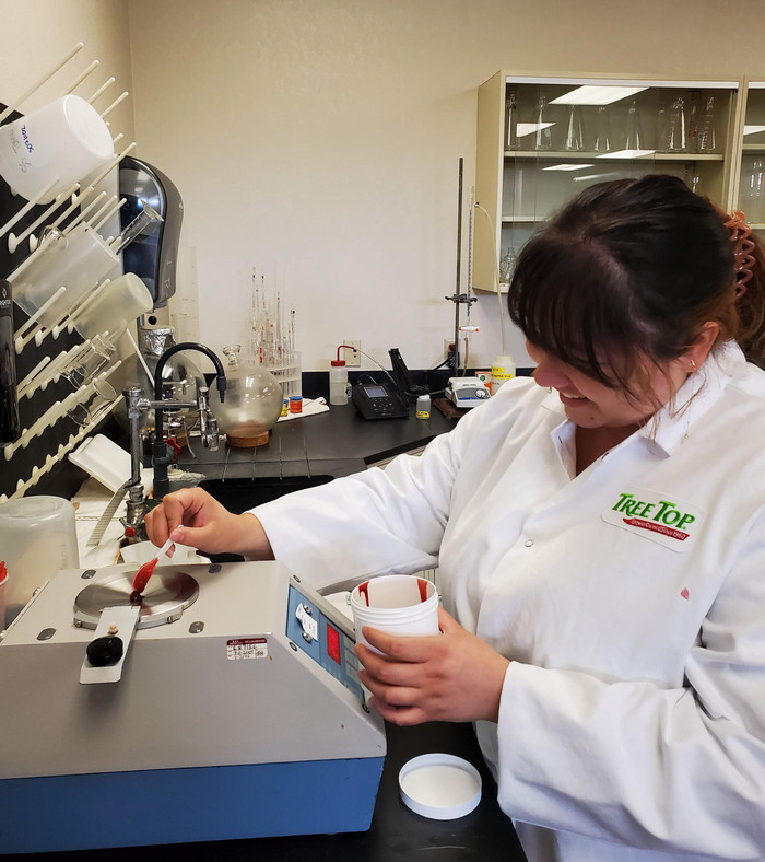 Grace working in a lab during her internship with Tree Top Foods