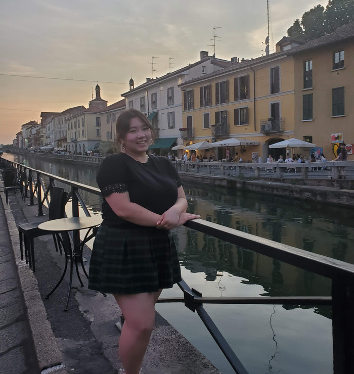 Grace standing next to a canal in Italy