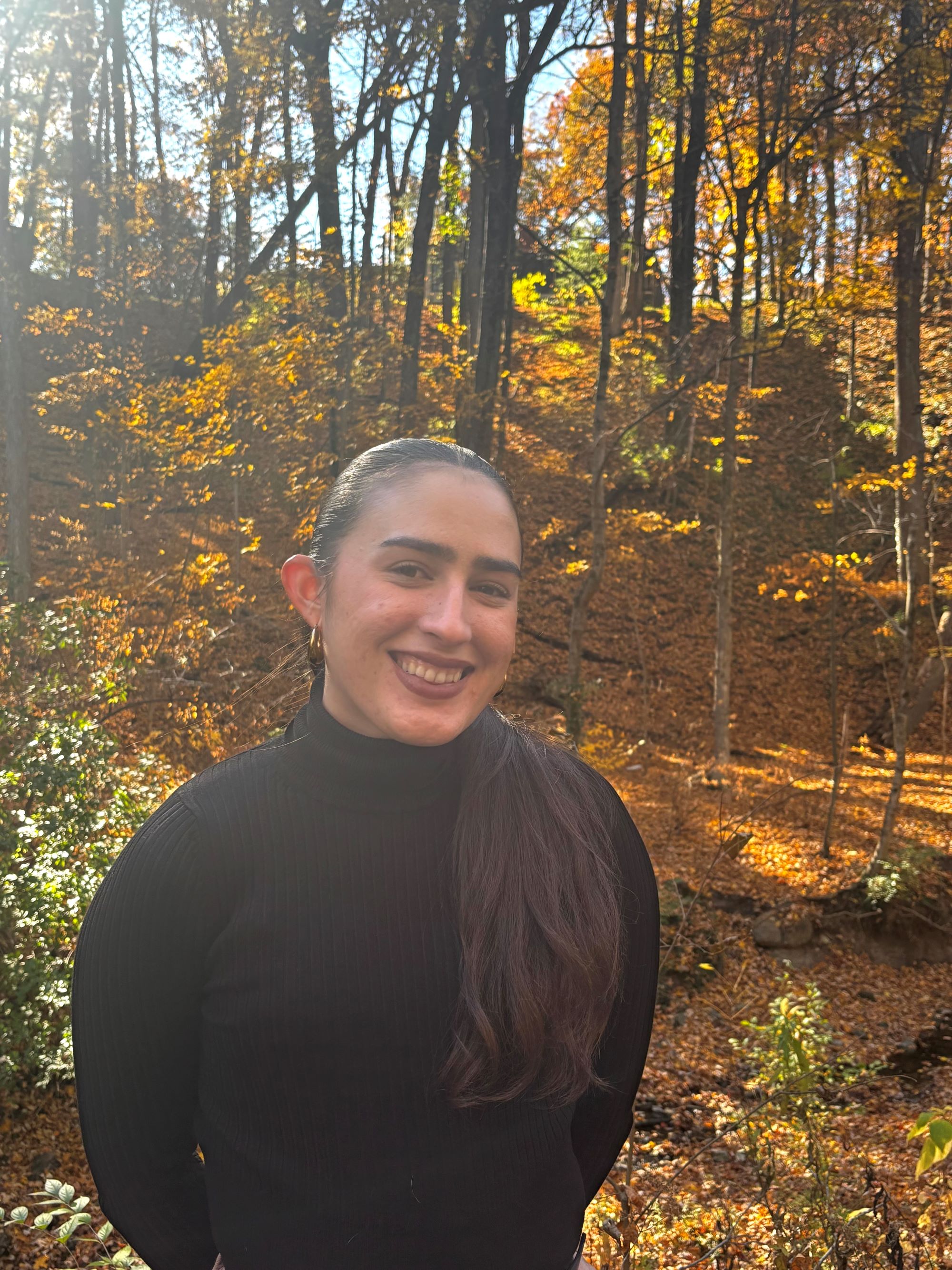 Keyshla Narvaez standing in the woods in the fall