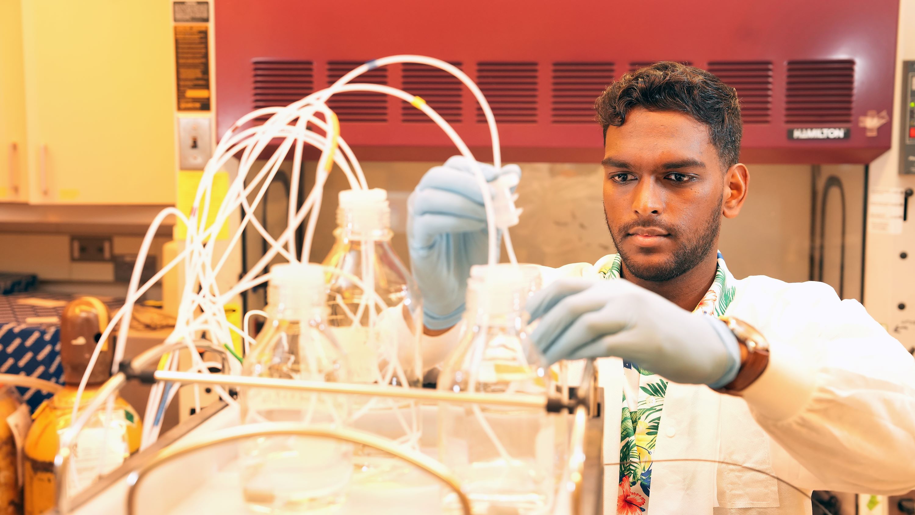 Student adjusting equipment in a lab