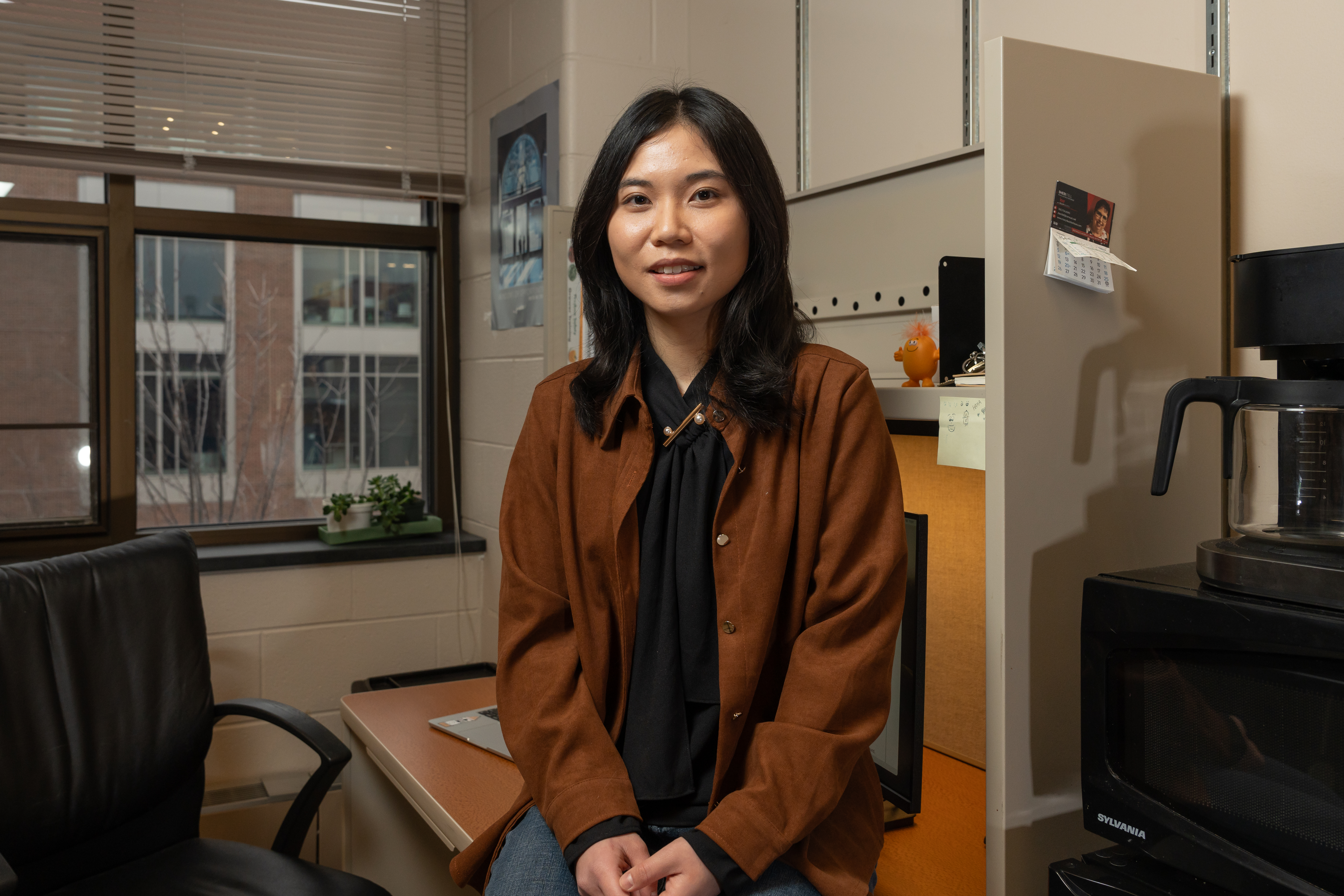 Han Chen sitting in a desk 