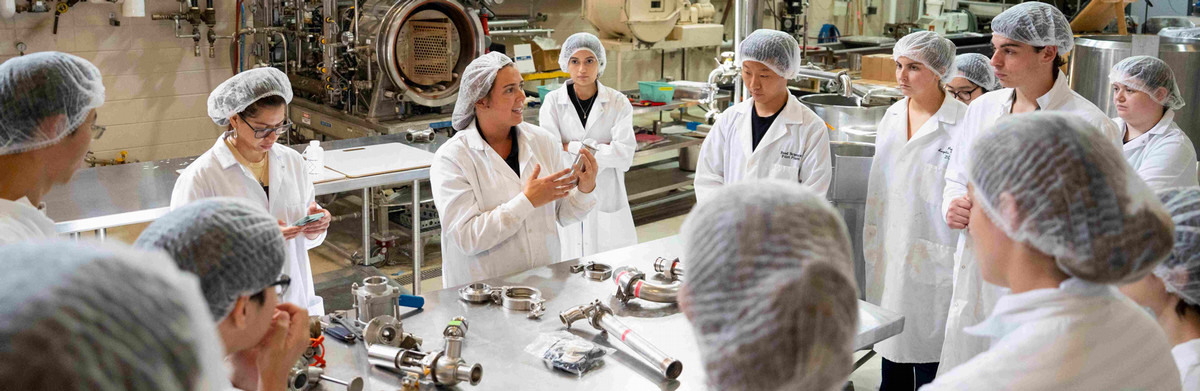 Lab manager explaining equipment to students