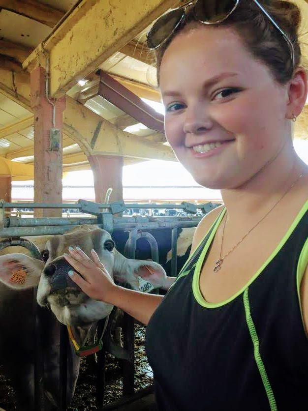 Student touching a cow in Italy