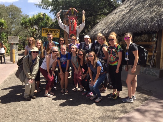 Students standing at the Equator in Ecuador