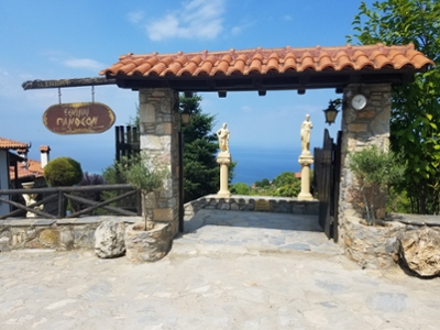 Landscape picture in Greece with trees, water, entrance gate