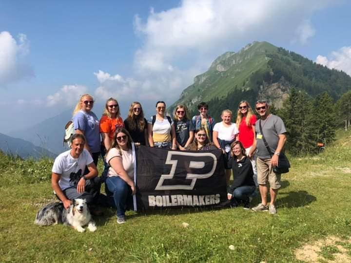 Students in The Alps of Italy with Purdue flag