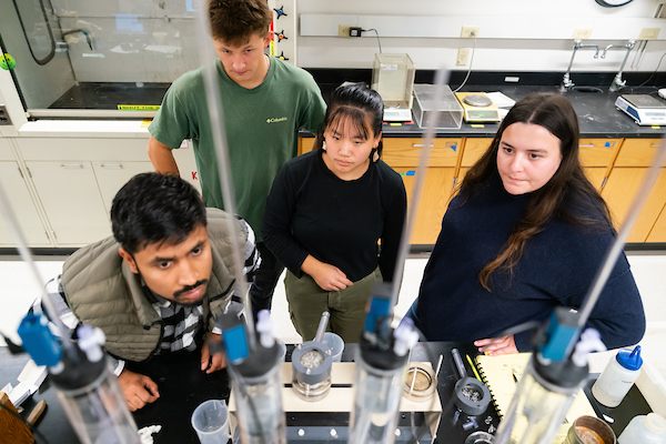 students sitting at lab table.