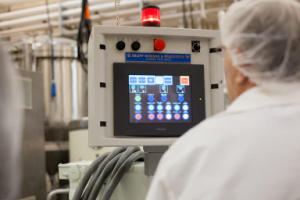 man in food processing facility at computer