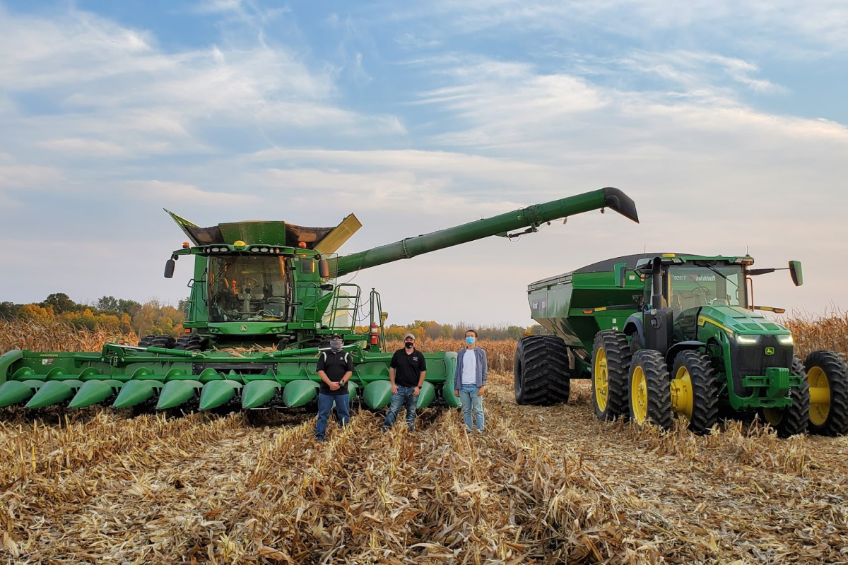 combine and grain card in corn field