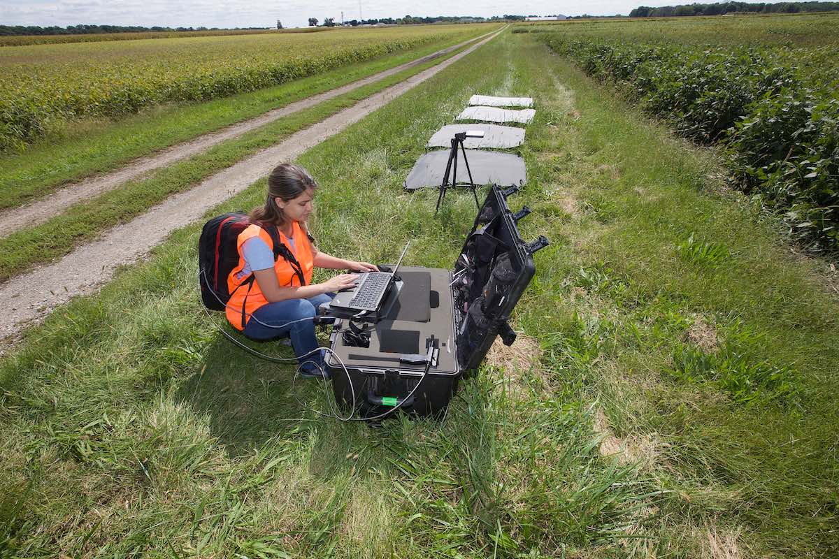 Student working with advance technology on a field