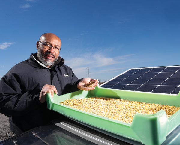 Klein Ileleji displays his prototype for a solar-powered crop dryer