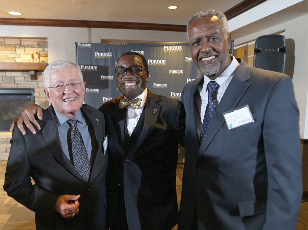 Purdue World Food Prize Laureates greet one another at the award ceremony: (l to r) Philip Nelson, Akinwumi Ayodeji Adesina, and Gebisa Ejeta