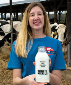 Kim Minich holds up a bottle of milk