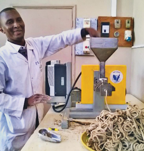 Mamadou Salif Sow, an engineer at the Institut de Technologie Alimentaire in Senegal, tests a small-scale extruder developed at Purdue. The extruder is now in use at incubation centers in Niger and Kenya, as well. 