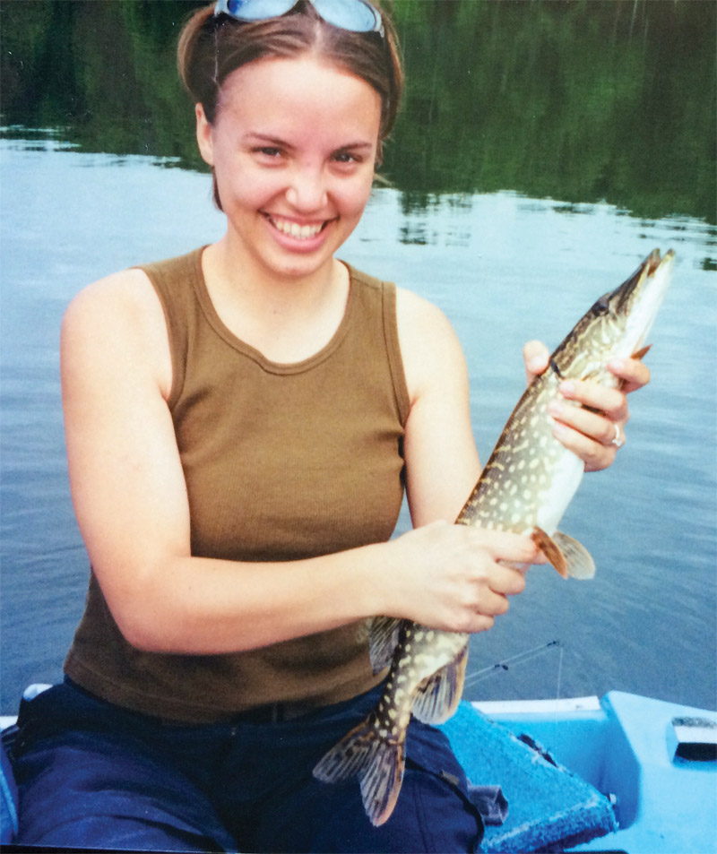 Cortney Mycroft holds a fish on a boat