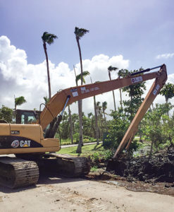 construction equipment does landscape work to repair hurricane damage