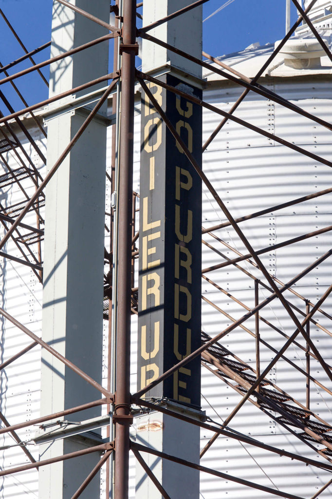 A sign reads Boiler Up beside a grain bin