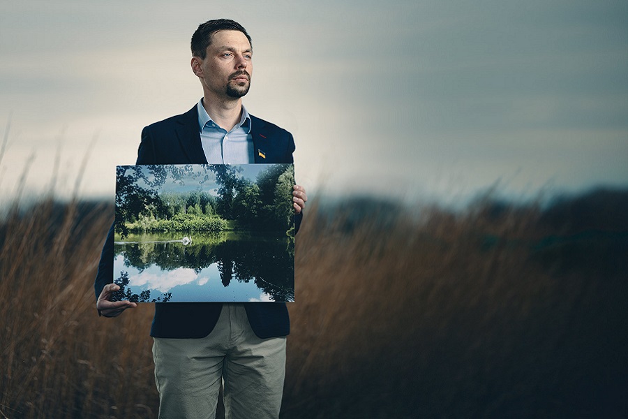 man holding a picture in a field
