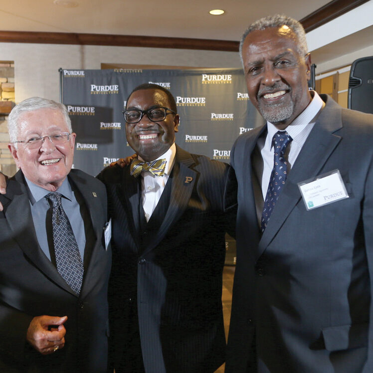 Purdue World Food Prize Laureates greet one another at the award ceremony: (l to r) Philip Nelson, Akinwumi Ayodeji Adesina, and Gebisa Ejeta