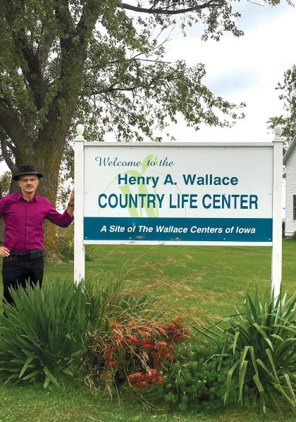Henery Wallace standing with welcome sign
