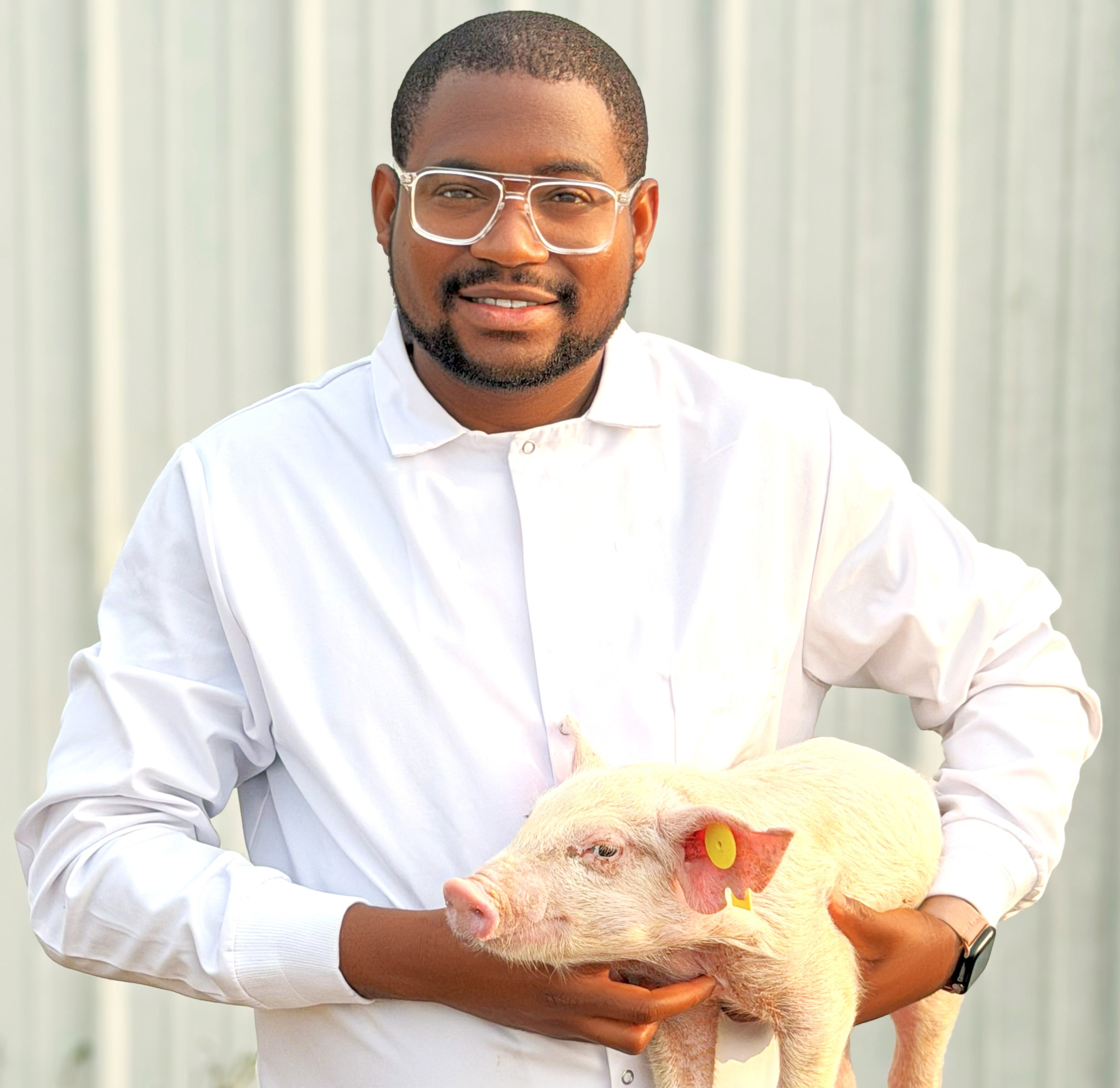 Abiola Lawal holds a pig.