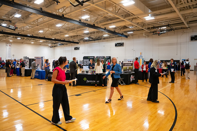 students walk through the career fair