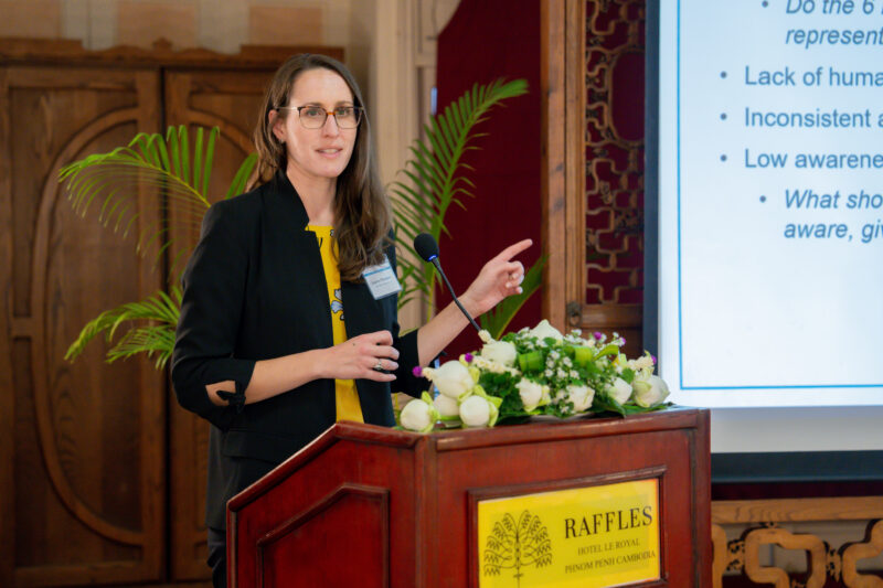 Lauren Trondsen standing at a podium presenting at stakeholder meeting.