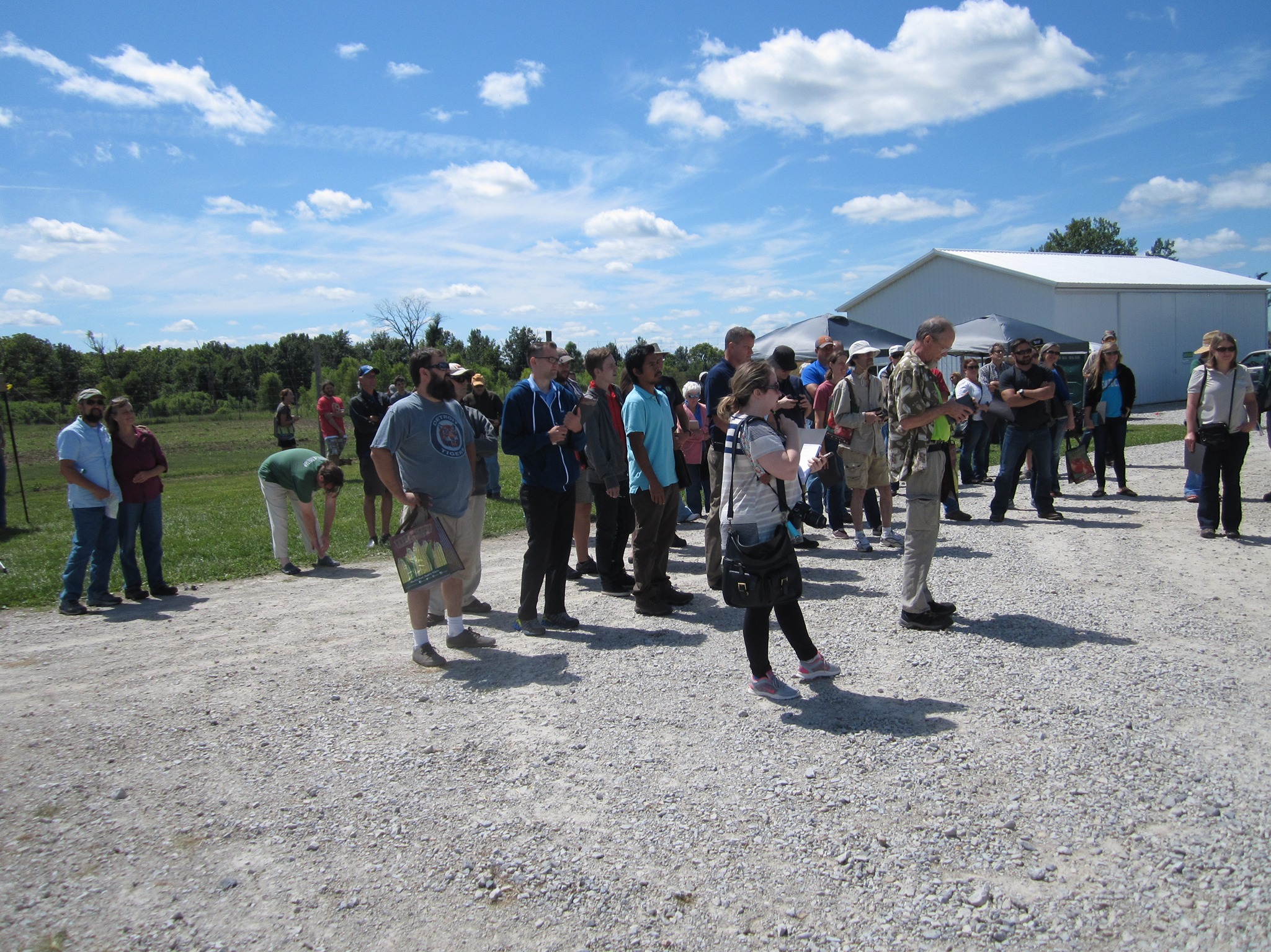Students and farmers watching Purdue researchers