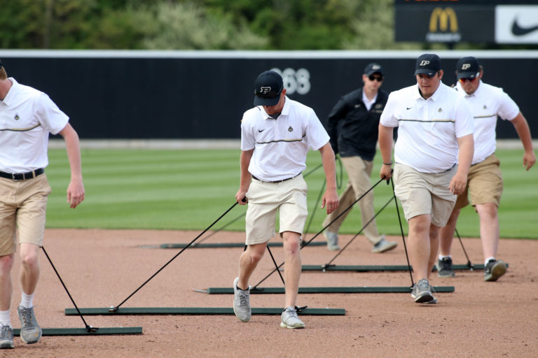 men cleaning golf course arena 