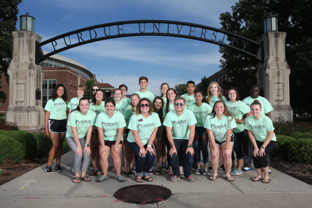 group of students outdoors in campus posing for picture