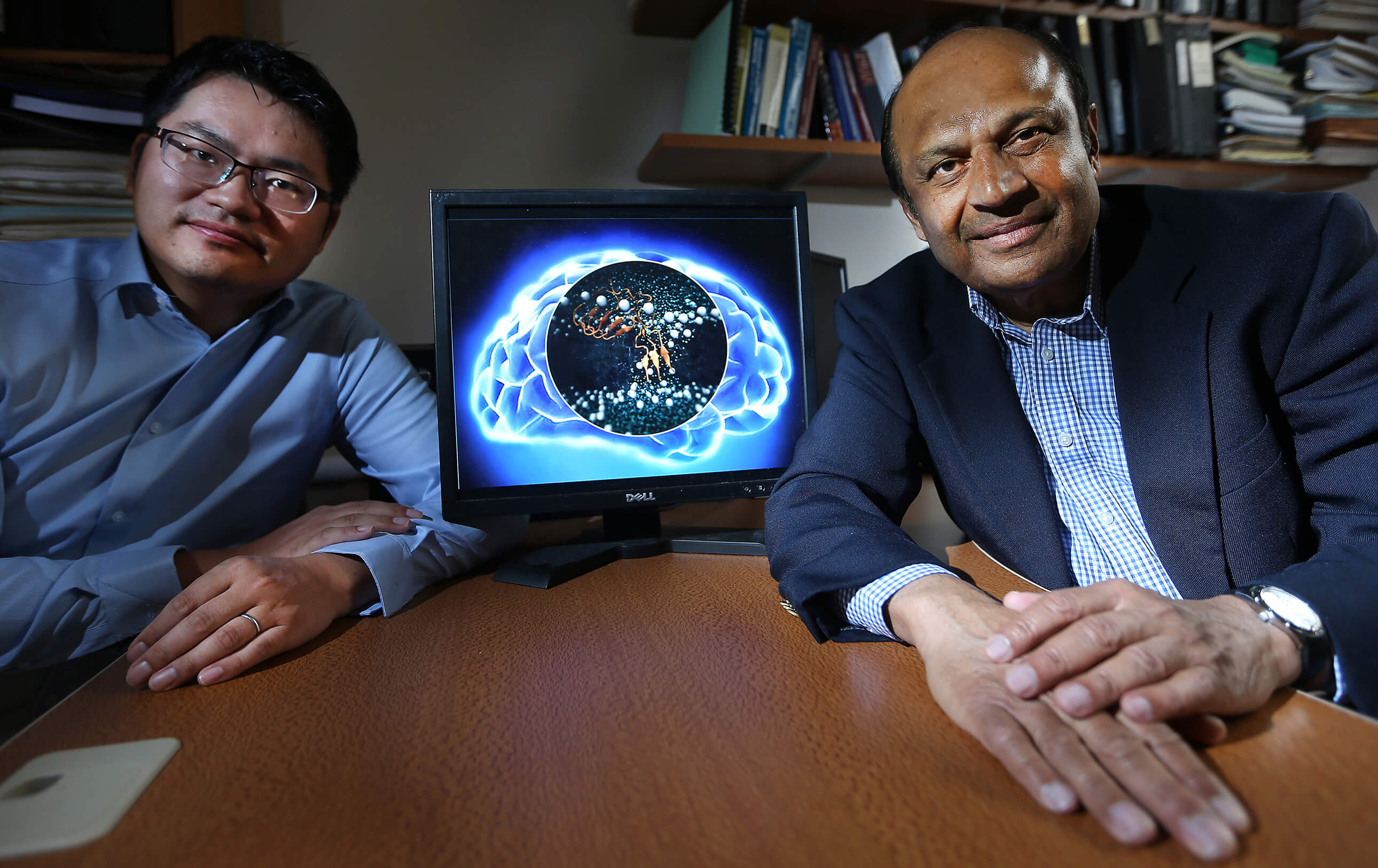 Ganesan Narsimhan (right) and Xiao Zhu simulated the effect beta-amyloid peptides have on neural cells, showing what may be the role these substances have in causing brain cell death and some neurodegenerative diseases, such as Alzheimer’s disease. (Purdue Ag Communication photo/Tom Campbell). 