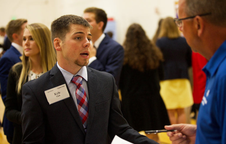 young man talking to a recruiter 