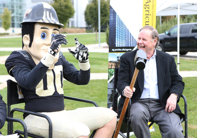 pit purdue mascot and man talking on a microphone